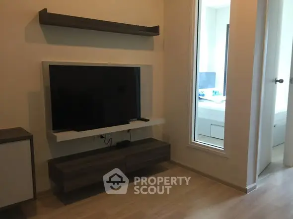 Modern living room with wall-mounted TV and sleek shelving