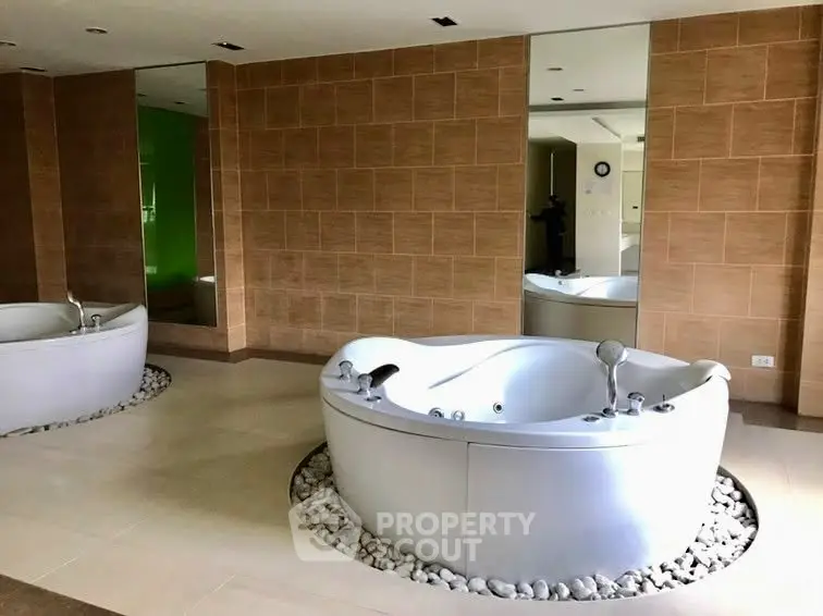 Luxurious spa-like bathroom with modern jacuzzi tub and elegant tile design.