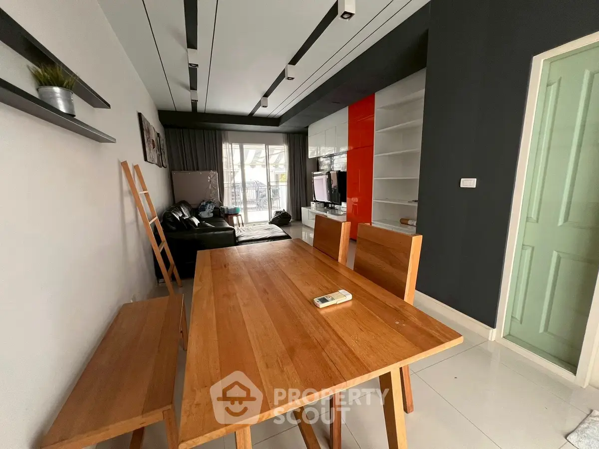 Modern living room with wooden dining table and sleek decor