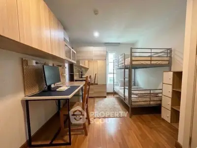 Modern study room with bunk beds and workspace, ideal for students or shared living.
