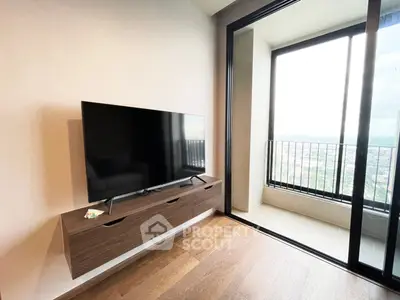 Modern living room with sleek TV unit and access to a spacious balcony with stunning views.