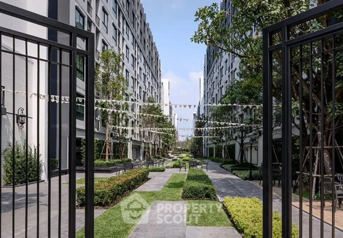 Modern apartment complex with lush landscaped gardens and open pathways.