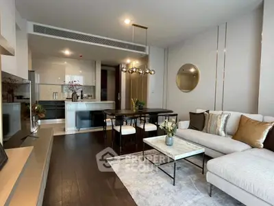 Modern living room with elegant decor and open kitchen layout in a stylish apartment.