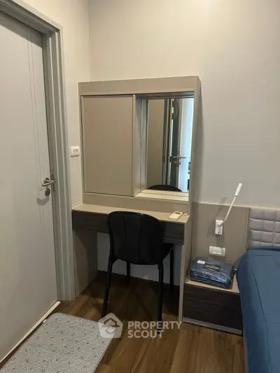 Cozy bedroom with modern vanity and comfortable bed in stylish apartment.