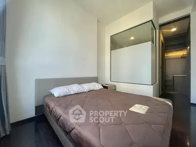 Modern bedroom with large window and cozy bed in a stylish apartment.