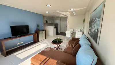 Spacious living room with modern decor and open kitchen layout