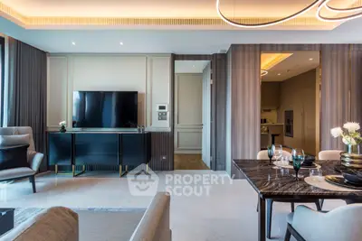 Luxurious modern living room with open kitchen, elegant decor, and sleek furniture in a high-end apartment.