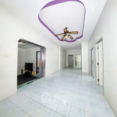 Spacious hallway with unique ceiling design and tiled flooring in modern home