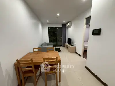 Modern living room with dining area and city view, perfect for urban living.