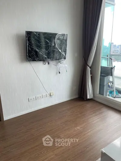 Modern living room with wall-mounted TV and balcony view