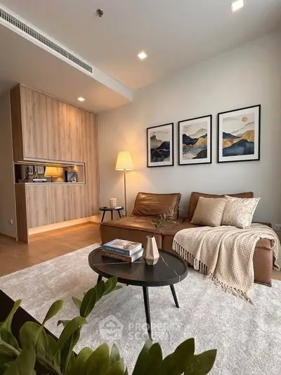 Stylish modern living room with cozy leather sofa, elegant decor, and warm lighting in a contemporary apartment.