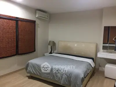 Cozy bedroom with modern decor and natural light, featuring a comfortable bed and stylish furnishings.