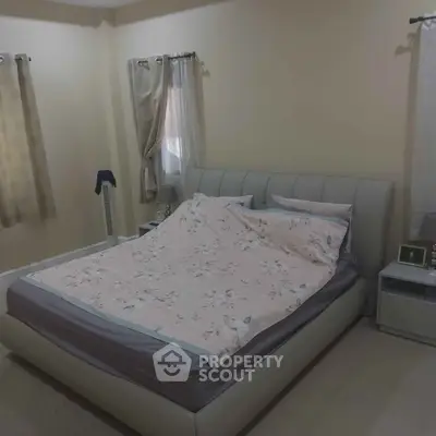 Cozy bedroom with elegant bed and soft lighting, perfect for relaxation.