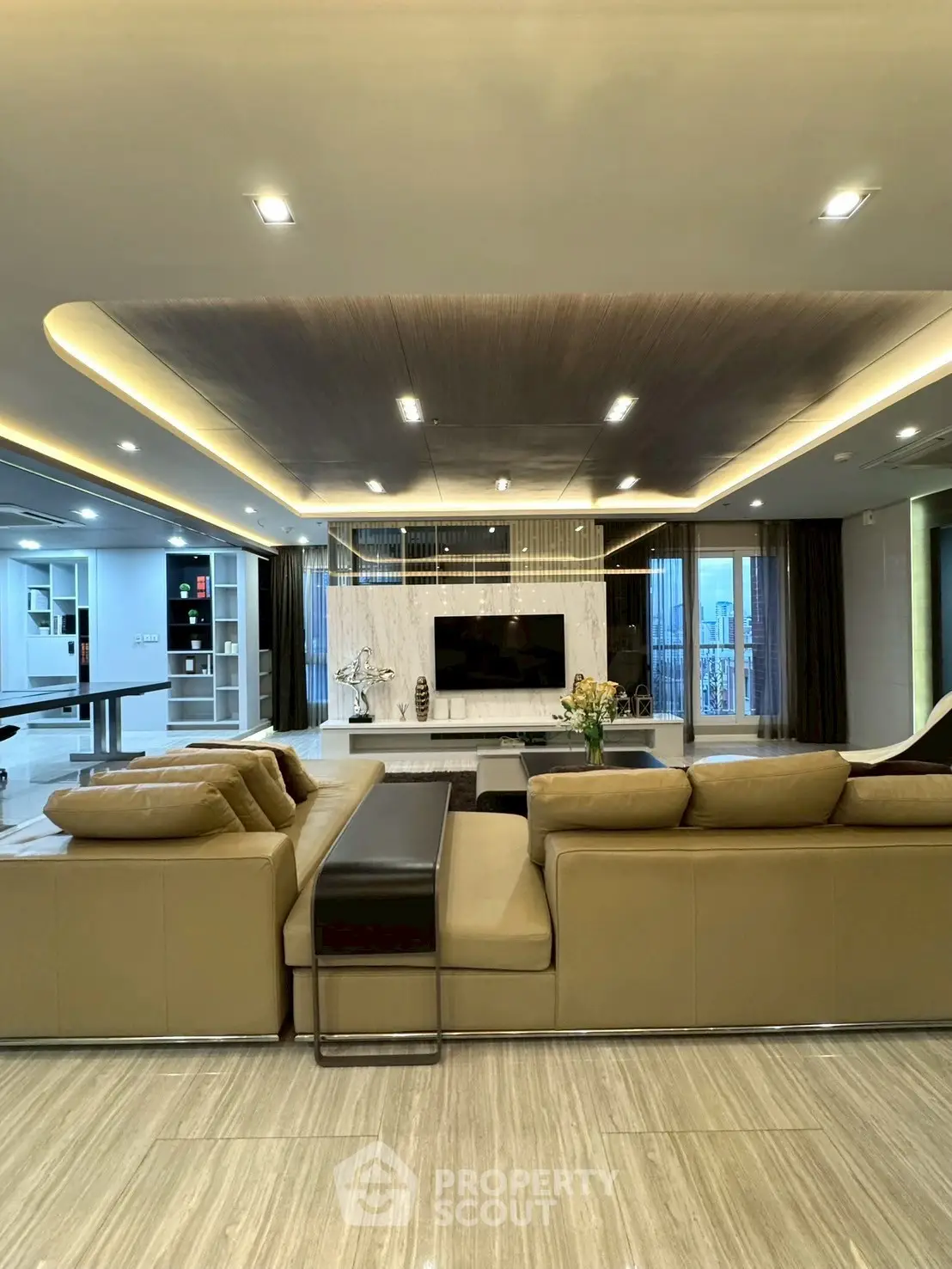 Luxurious modern living room with elegant lighting and spacious seating area.