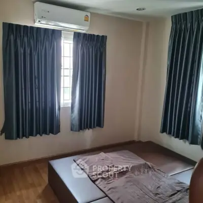 Cozy bedroom with air conditioning and dark curtains, perfect for restful nights.