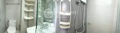 Modern bathroom with shower, toilet, and sink in a compact layout.