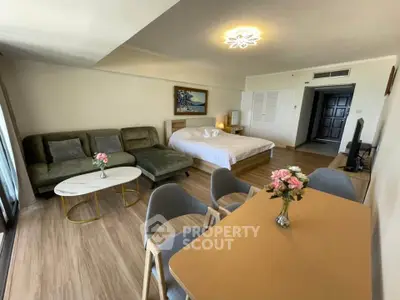 Spacious studio apartment with modern furnishings and elegant decor, featuring a cozy living area and dining space.