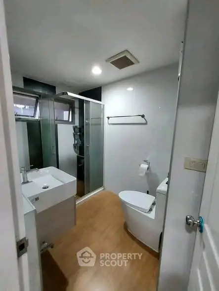 Modern bathroom with sleek fixtures and glass shower enclosure