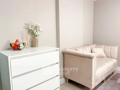 Chic and cozy living room corner with elegant sofa and modern dresser, perfect for stylish urban living.