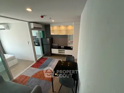 Modern apartment interior with open layout, featuring a cozy living area and stylish kitchen.