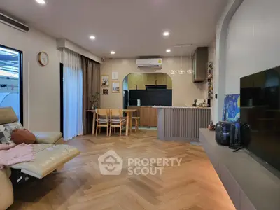 Modern open-plan living room with stylish kitchen and cozy seating area