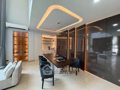 Luxurious modern living room with elegant lighting and sleek furniture design.