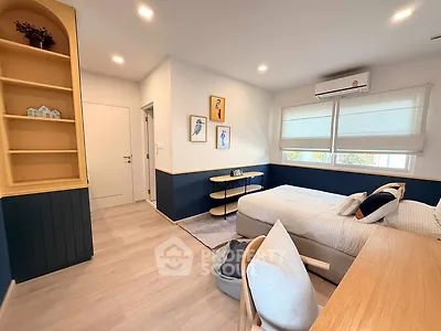 Modern bedroom with stylish decor and natural light, featuring cozy bed and elegant furnishings.