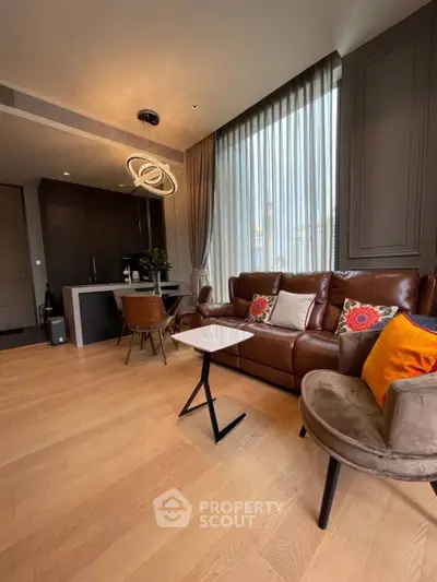 Modern living room with stylish furniture and open kitchen layout