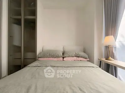 Cozy bedroom with modern decor and soft lighting, featuring a comfortable bed and stylish lamp.