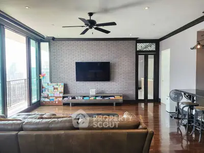 Spacious living room with modern decor and city view balcony, perfect for urban living.