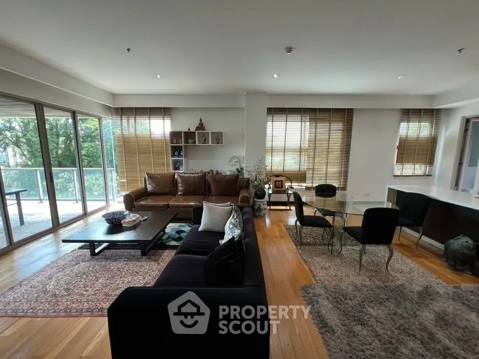 Spacious living room with large windows and stylish furniture, offering a cozy and inviting atmosphere.