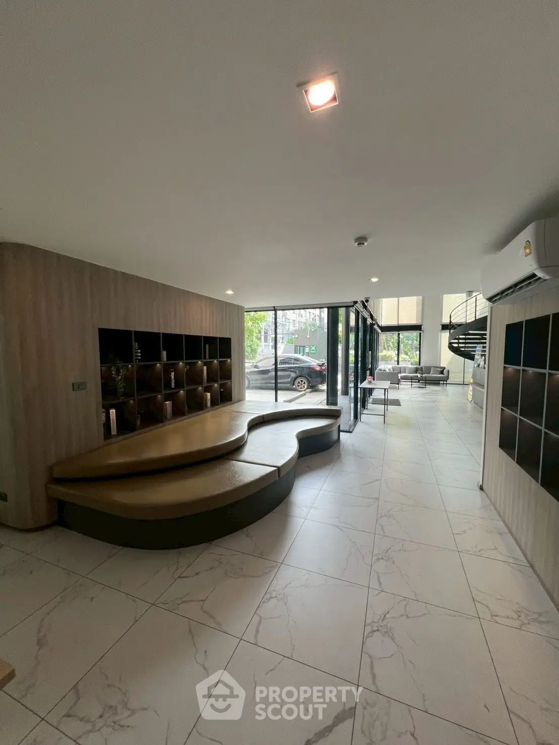 Modern lobby with stylish seating and large windows in a contemporary building.