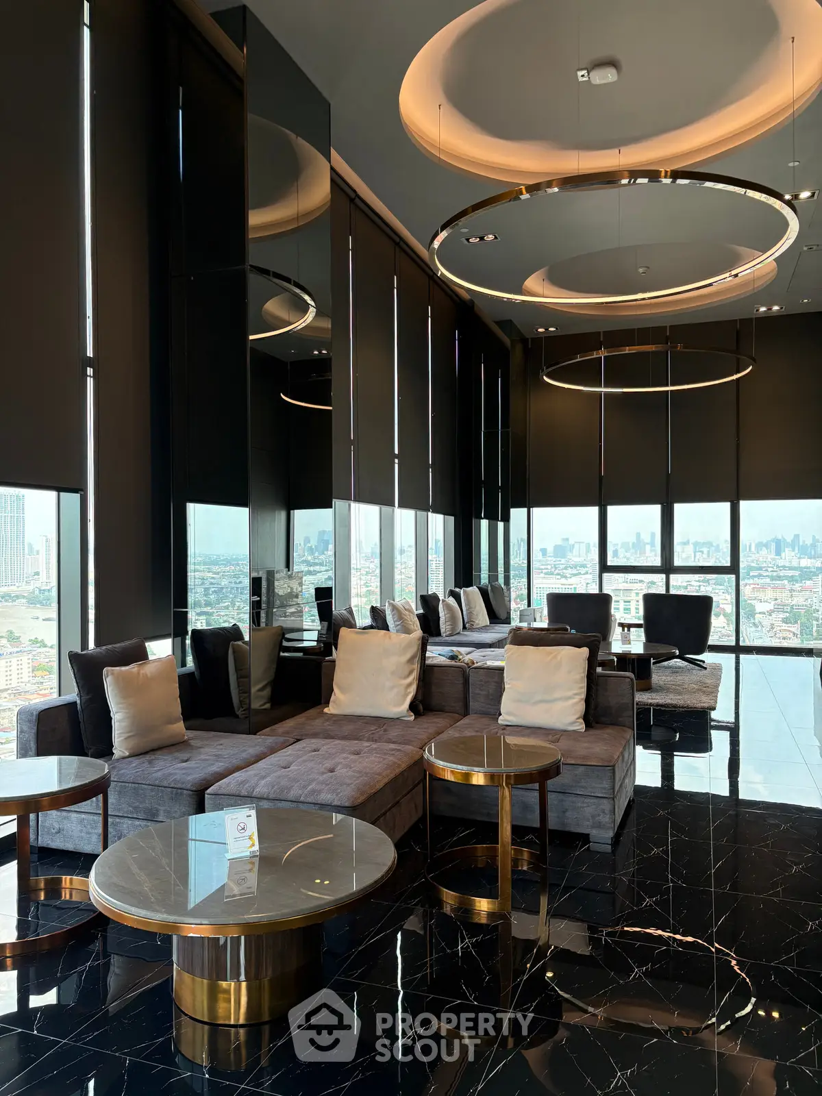 Luxurious high-rise living room with panoramic city views and elegant modern furnishings.