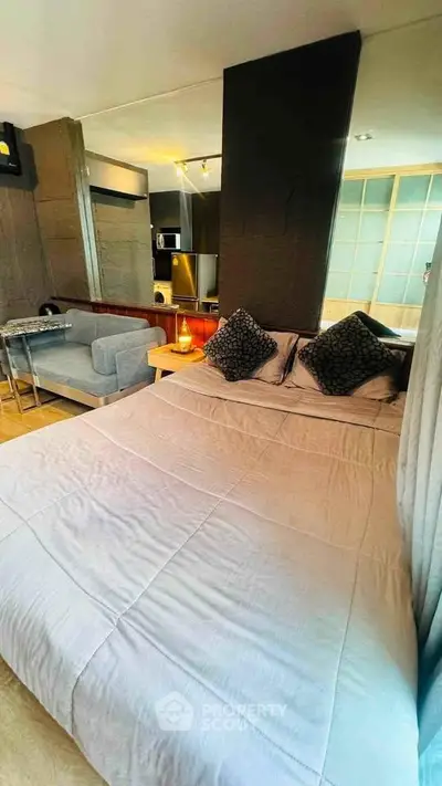 Modern studio apartment with cozy bed and stylish decor