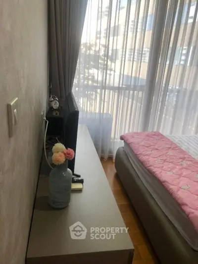 Cozy bedroom with modern decor and large window view