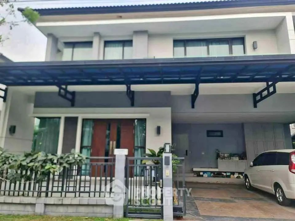 Modern two-story house with carport and sleek design