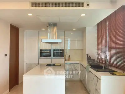 Luxurious modern kitchen with sleek white cabinetry and marble countertops