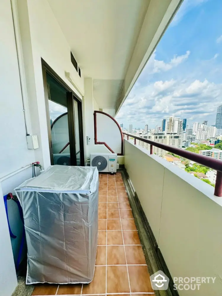 High-rise balcony with city view and air conditioning units