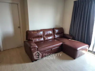 Cozy living room with stylish brown leather sofa and natural light