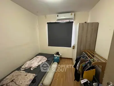 Cozy bedroom with air conditioning and minimalist decor, perfect for a comfortable living experience.