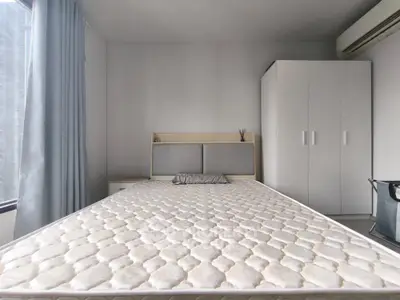 Modern minimalist bedroom with large window and sleek wardrobe