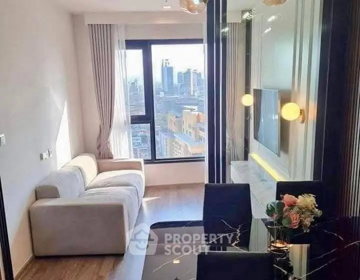 Modern living room with city view, elegant decor, and cozy seating area.