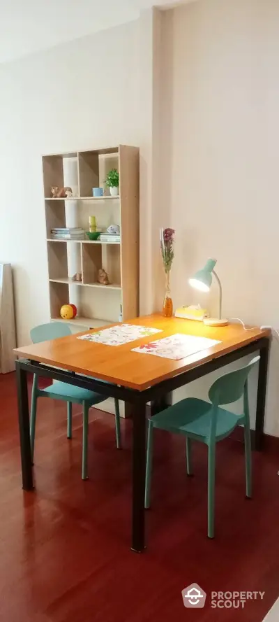 Cozy dining area with modern table and chairs, perfect for small apartments.