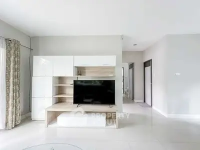 Modern living room with sleek TV unit and neutral decor