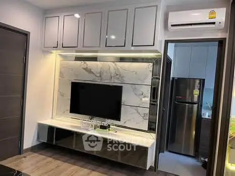 Modern living room with sleek TV unit and stylish kitchen view