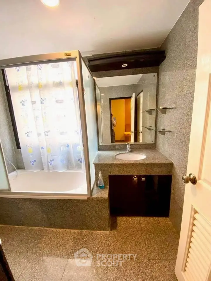 Spacious bathroom with modern fixtures and granite countertop
