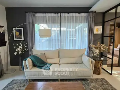 Stylish living room with modern decor and large window for natural light
