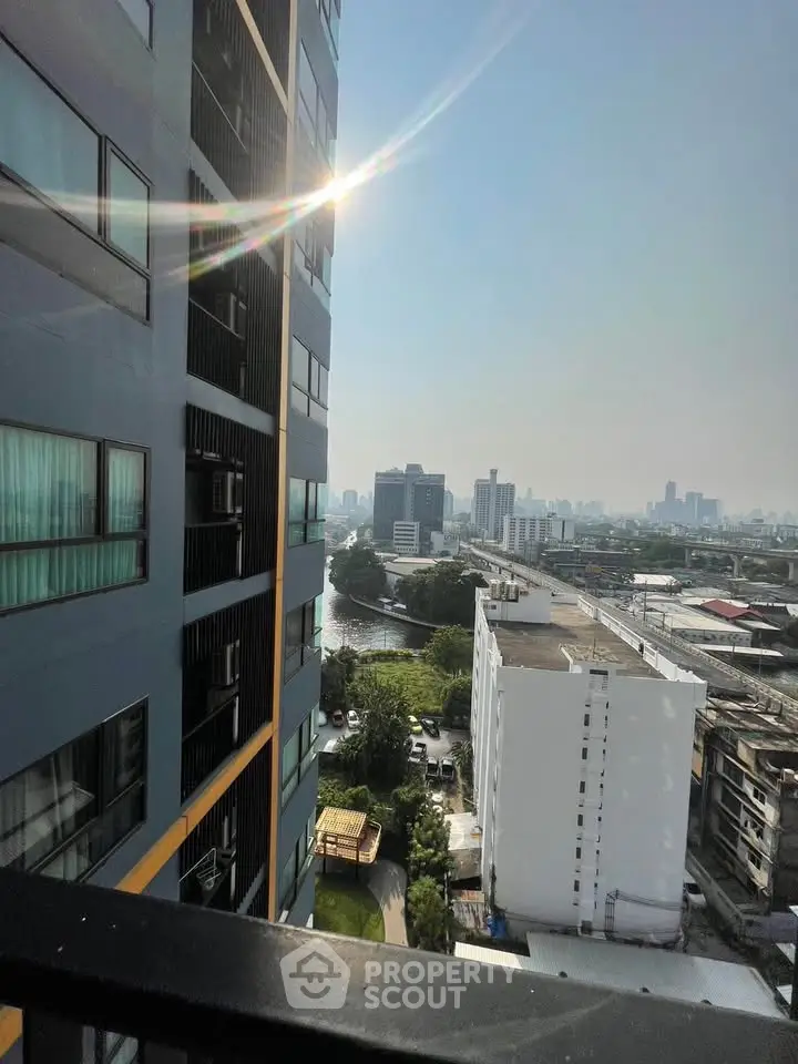 Stunning cityscape view from high-rise balcony with river and skyline.