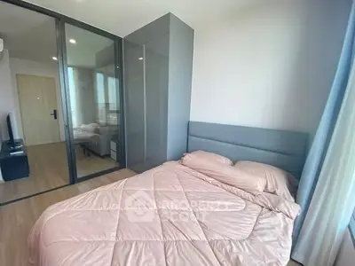 Modern bedroom with glass wardrobe and cozy pink bedding