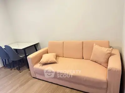 Cozy living room with peach sofa and modern dining table set